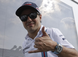 Williams driver Felipe Massa of Brazil cheers as he walks in the paddock at the Monza racetrack, in Monza, Italy , Thursday, Sept. 1, 2016. With a dedication to mentor Michael Schumacher, Williams driver Felipe Massa announced Thursday that he will retire from Formula One at the end of the season. (AP Photo/Luca Bruno)