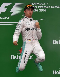 Winner Mercedes AMG Petronas F1 Team's German driver Nico Rosberg (C) celebrates on the podium next to second placed Mercedes AMG Petronas F1 Team's British driver Lewis Hamilton (L) and third placed Scuderia Ferrari's German driver Sebastian Vettel following the Italian Formula One Grand Prix at the Autodromo Nazionale circuit in Monza on September 4, 2016. / AFP PHOTO / GABRIEL BOUYS