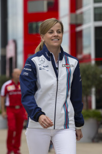 Williams test driver Susie Wolff walks through the paddock area before the British Formula One Grand Prix meeting at Silverstone circuit, Silverstone, England, Thursday, July 2, 2015. The British Formula One Grand Prix will be held on Sunday July 5. (AP Photo/Jon Super)