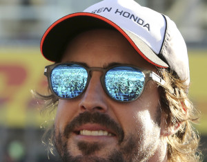 Spectators are reflected on sunglasses of McLaren driver Fernando Alonso of Spain upon his arrival for a fan meeting at the Suzuka Circuit in Suzuka, central Japan, Thursday, Oct. 6, 2016, ahead of Sunday's Japanese Formula One Grand Prix. (AP Photo/Toru Takahashi)