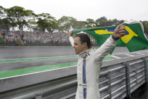 Williams driver Felipe Massa, of Brazil, walks along the track with a Brazilian flag after crashing during the Brazilian Formula One Grand Prix at the Interlagos race track in Sao Paulo, Brazil, Sunday, Nov. 13, 2016. Massa announces he will retire from Formula One after this season. (AP Photo/Leo Correa)