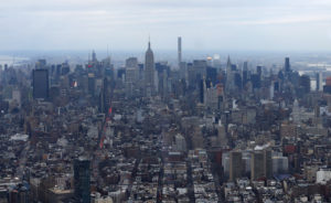 A super slim skyscraper at 432 Park Avenue competes with the Empire State building as it juts above the Manhattan skyline as seen from the One World Observatory, Wednesday, Feb. 17, 2016, in New York. Among the structures going up in the construction boom of recent years, there are a few that are reshaping the look of the skyline and doing it with footprints that take up a fraction of the space at ground level. (AP Photo/Julie Jacobson)