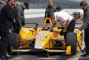 Race driver Fernando Alonso of Spain prepares to drive for the first time at the Indianapolis Motor Speedway in Indianapolis, Wednesday, May 3, 2017. Alonso plans to miss the Monaco Grand Prix this year to drive in the Indianapolis 500. (AP Photo/Michael Conroy)