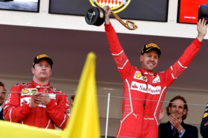 Winner Ferrari's German driver Sebastian Vettel (R) celebrates on the podium next to second placed Ferrari's Finnish driver Kimi Raikkonen after the Monaco Formula 1 Grand Prix at the Monaco street circuit, on May 28, 2017 in Monaco. / AFP PHOTO / ANDREJ ISAKOVIC