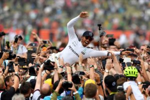 Winner Mercedes' British driver Lewis Hamilton is celebrated by fans after the British Formula One Grand Prix at the Silverstone motor racing circuit in Silverstone, central England on July 16, 2017. / AFP PHOTO / Ben STANSALL