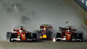 Ferrari driver Kimi Raikkonen, right, of Finland collides with teammate Sebastian Vettel of Germany, left, and Red Bull driver Max Verstappen of the Netherlands at the start of the Singapore Formula One Grand Prix on the Marina Bay City Circuit Singapore, Sunday, Sept. 17, 2017. (AP Photo/Yong Teck Lim)