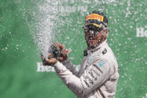 Mercedes driver Lewis Hamilton celebrates his victory in the Formula One Mexico Grand Prix auto race at the Hermanos Rodriguez racetrack in Mexico City, Sunday, Oct. 30, 2016. Hamilton won the race ahead of fellow Mercedes driver Nico Rosberg and Ferrari driver Sebastian Vettel. (AP Photo/Eduardo Verdugo)