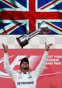 Formula One F1 - Japanese Grand Prix 2017 - Suzuka Circuit, Japan - October 8, 2017. Mercedes' Lewis Hamilton of Britain throws his trophy into the air as he celebrates winning the race. REUTERS/Toru Hanai