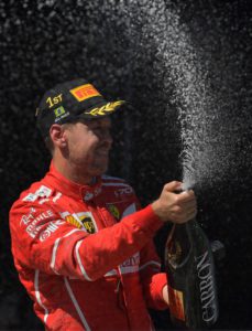 Ferrari's German driver Sebastian Vettel celebrates on the podium after winning the Brazilian Formula One Grand Prix, at the Interlagos circuit in Sao Paulo, Brazil, on November 12, 2017. / AFP PHOTO / Carl DE SOUZA