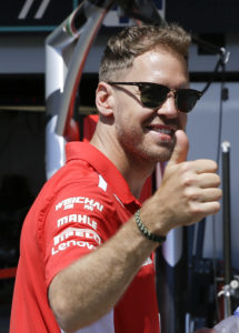 Ferrari driver Sebastian Vettel of Germany gestures as he walks in the pits at the Baku Formula One city circuit, in Baku, Azerbaijan, Thursday, April 26, 2018. The Formula one race will be held on Sunday. (AP Photo/Luca Bruno)