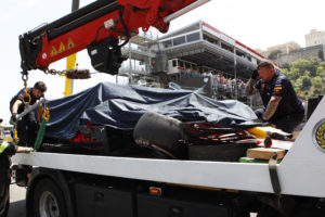 A truck lifts the car of Red Bull driver Max Verstappen of the Netherlands during the third free practice at the Monaco racetrack, in Monaco, Saturday, May 26, 2018. The Formula one race will be held on Sunday. (AP Photo/Claude Paris)