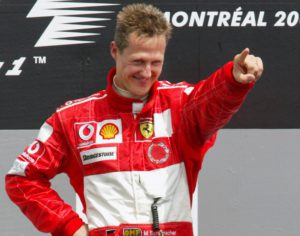 Michael Schumacher, from Germany, points to cheering Ferrari fans as he takes to the podium after winning the Canadian Grand Prix, Sunday, June 13, 2004 in Montreal. (AP Photo/Paul Chiasson) COPYRIGHT PRESSENS BILD Code: 436