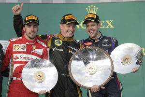 Lotus driver Kimi Raikkonen of Finland, center, celebrates with Ferrari's Fernando Alonso of Spain, left, and Red Bull's Sebastian Vettel of Germany after the Australian Formula One Grand Prix at Albert Park in Melbourne, Australia, Sunday, March 17, 2013. Raikkonen won ahead of Alonso second and Vettel third. (AP Photo/Rob Griffith)
