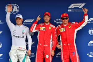 Mercedes' Finnish driver Valtteri Bottas (L) Ferrari's German driver Sebastian Vettel (C) and Ferrari's Finnish driver Kimi Raikkonen pose after the qualifying session on the eve of the German Formula One Grand Prix at the Hockenheimring Baden-Württemberg in Hockenheim, on July 21, 2018. Sebastian Vettel surged to pole for his home German Grand Prix ahead of Bottas and Raikkonen. / AFP PHOTO / Andrej ISAKOVIC