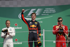 Red Bull driver Max Verstappen of the Netherlands, center, celebrates winning the Formula One Mexico Grand Prix auto race at the Hermanos Rodriguez racetrack in Mexico City, Sunday, Oct. 29, 2017. At left is Mercedes driver Valtteri Bottas, of Finland, who placed second, and at right is Ferrari driver Kimi Raikkonen, of Finland, who placed third. (AP Photo/Moises Castillo)