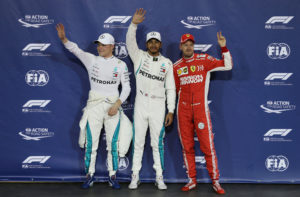 Formula One F1 - Abu Dhabi Grand Prix - Yas Marina Circuit, Abu Dhabi, United Arab Emirates - November 24, 2018 Mercedes' Lewis Hamilton celebrates pole position as second place Mercedes' Valtteri Bottas and third place Ferrari's Sebastian Vettel look on REUTERS/Hamad I Mohammed
