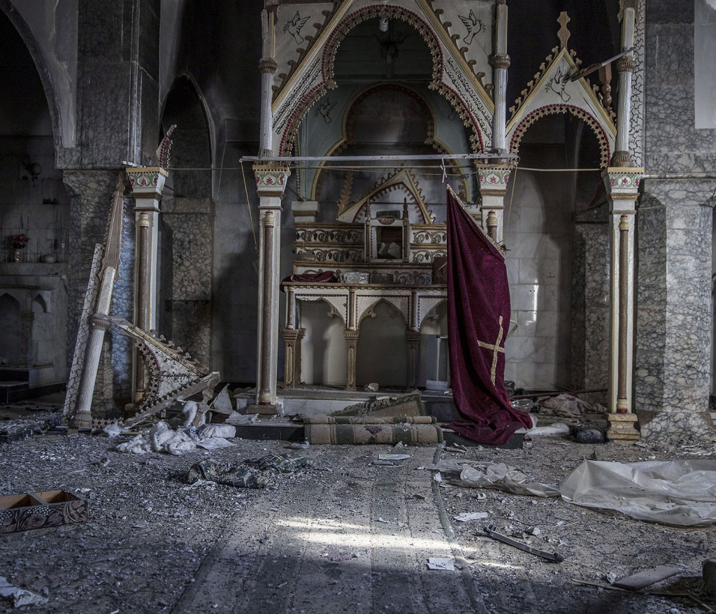 foto : magnus wennman : nästan allt i staden bartella strax utanför mosul är plundrat av is och sönderbombat. kyrkan är förstörd och gravar plundrade. huvudet och händerna på kristusstatyn är avslitna. bisarra spår i form av texter med människans svaga punkter och krigarnas scheman. några få kristna familjer återvänder för att titta till sina totalförstörda och plundrade hus. det kommer dröja länge innan någon flyttar tillbaka till staden.